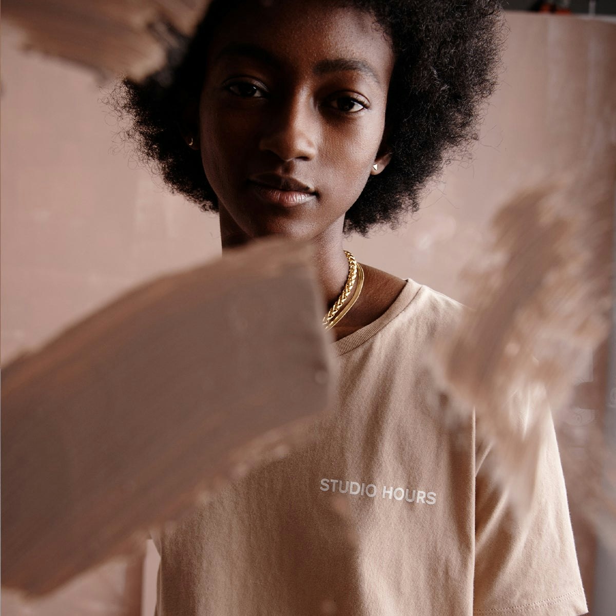 A person wearing a STUDIO HOURS Tshirt from the Backdrop x Madewell collection