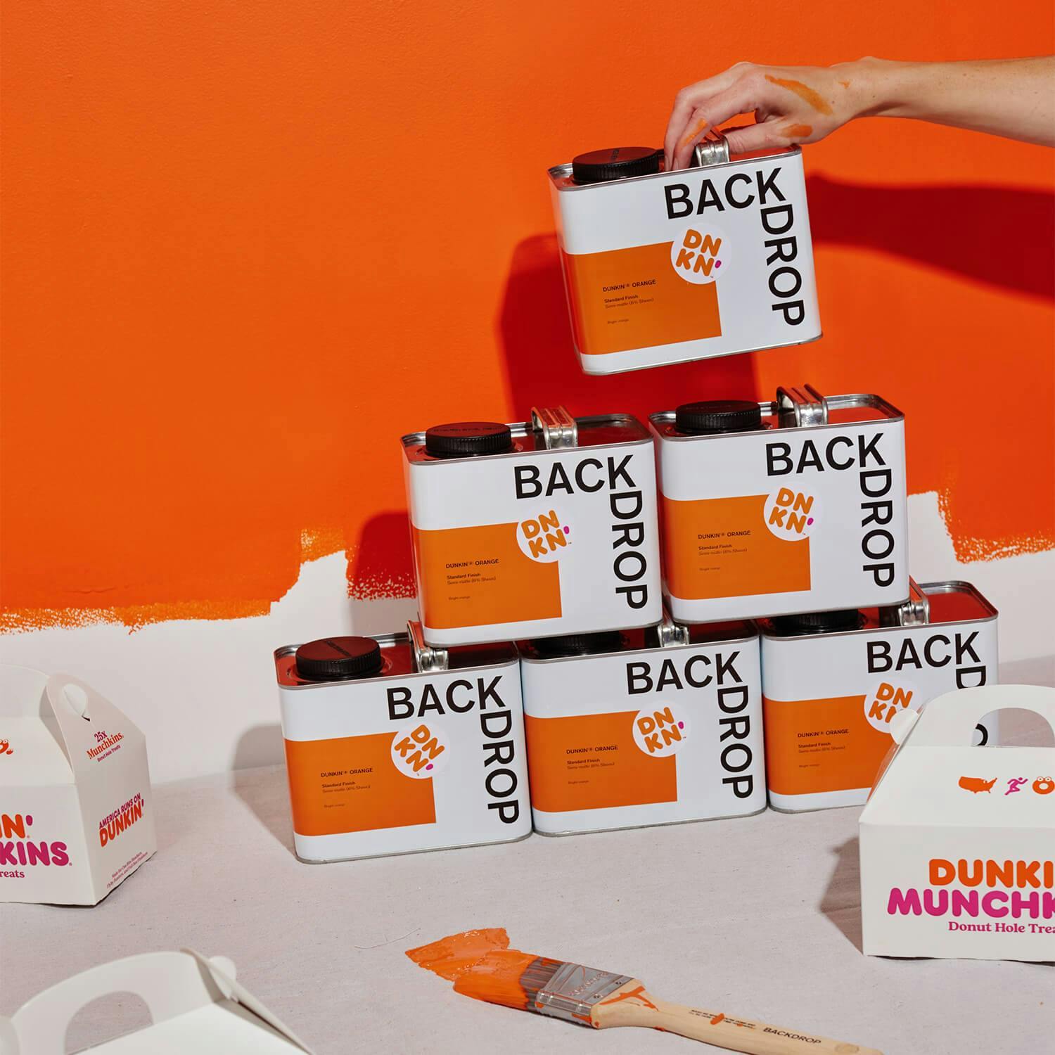 A stack of Dunkin® Orange paint cans