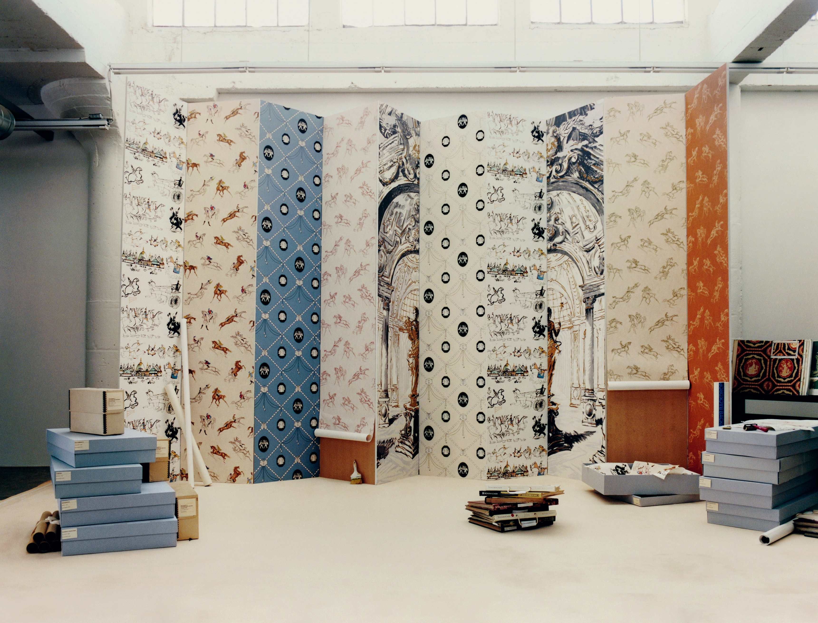 ARCHIVE by BACKDROP wallpaper designs installed on a paneled wall on a set inspired by an archival library and a vintage Schumacher advertisement