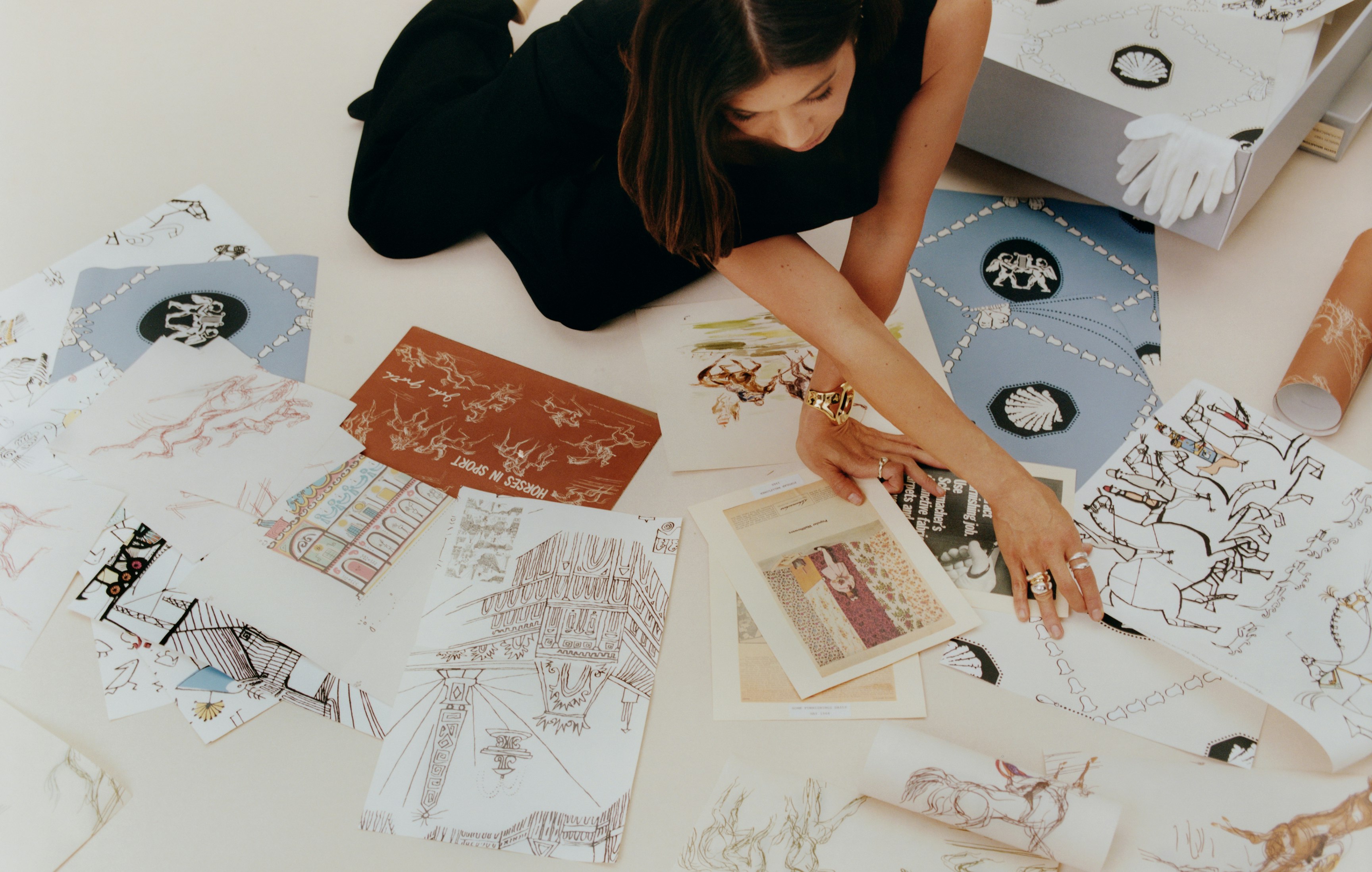 Backdrop's founder looks through wallpaper samples, archive ads, and inspiration for ARCHIVE by BACKDROP, a new wallpaper collection