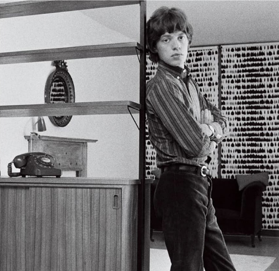 The arbiter of cool poses in his London flat against a wall in the still-popular Queen of Spain design.